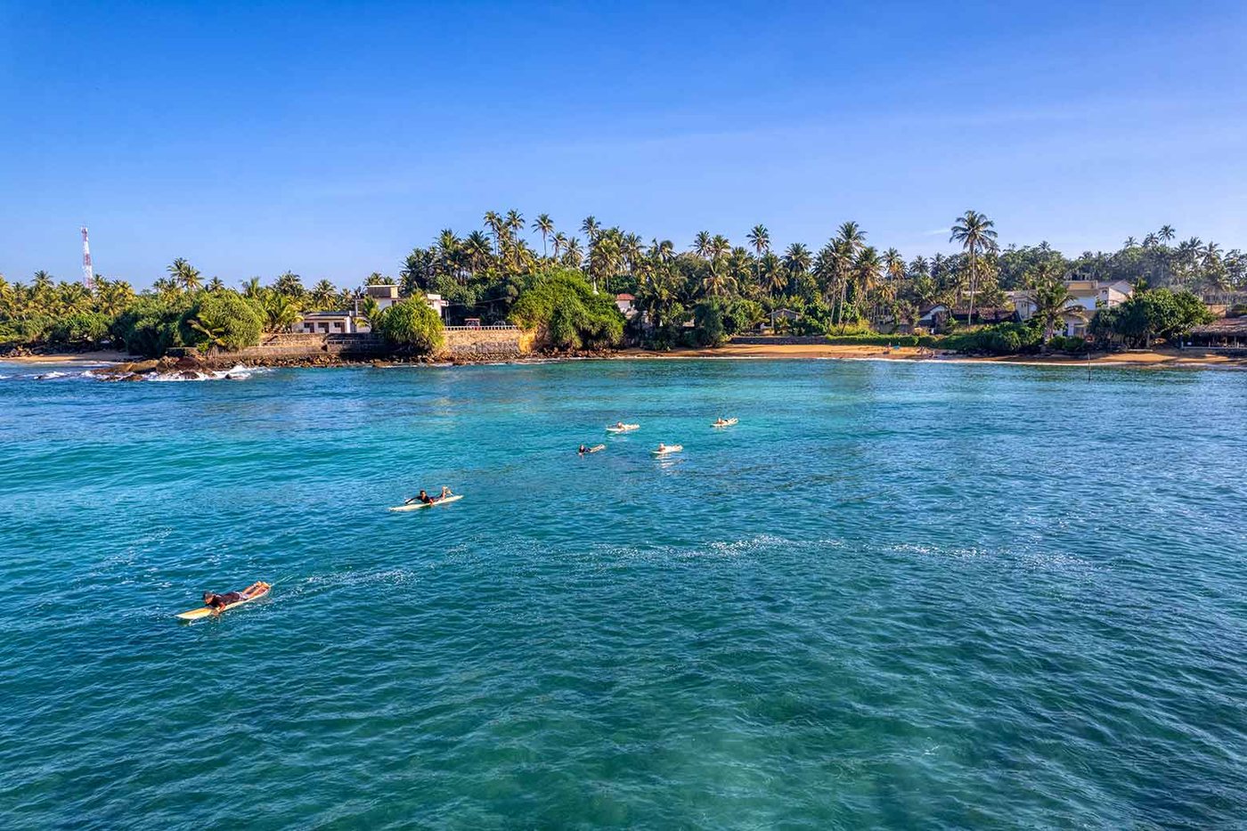 Surfers off Sri Lanka's south coast